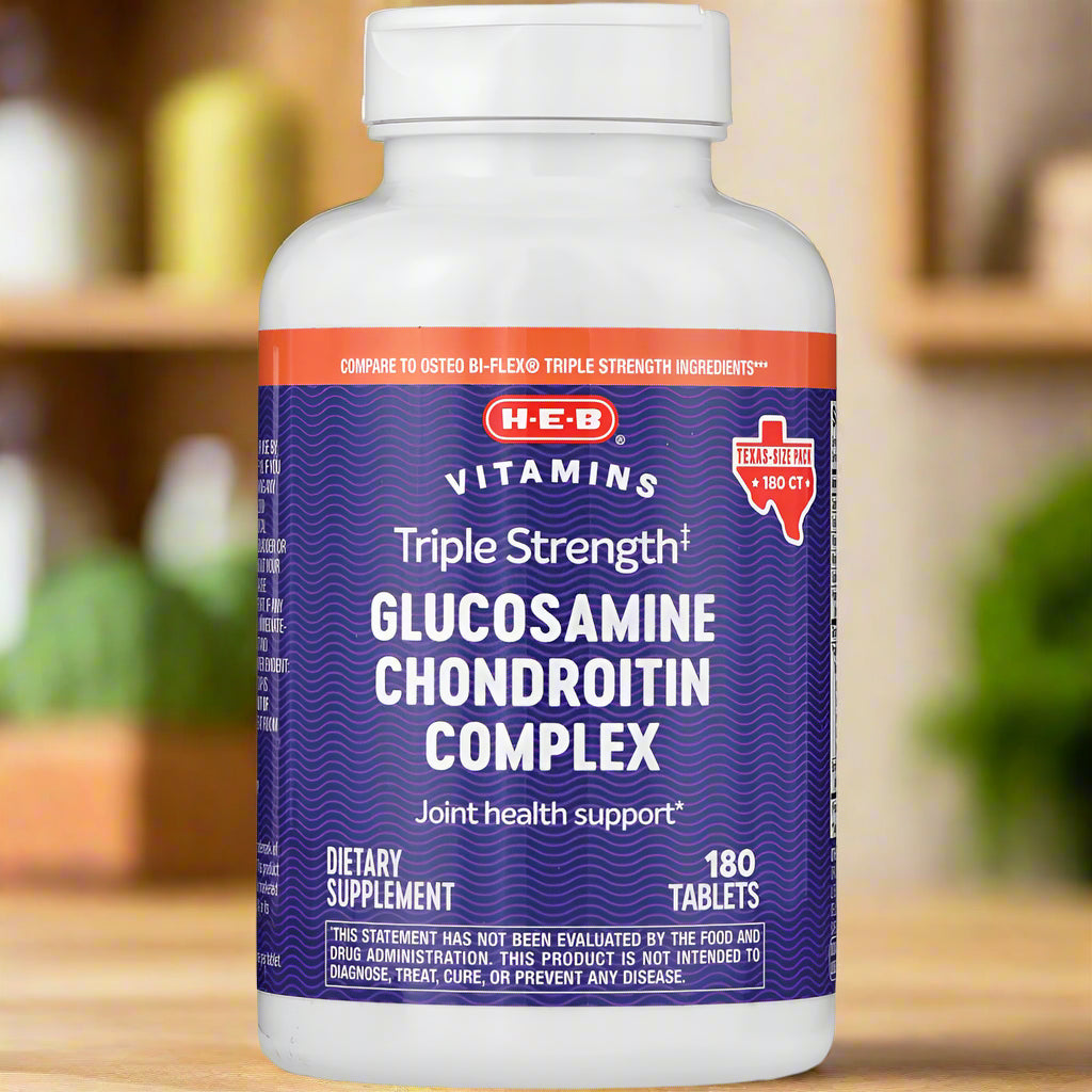 Bottle of H-E-B Triple Strength Glucosamine Chondroitin Complex supplement on a wooden surface.