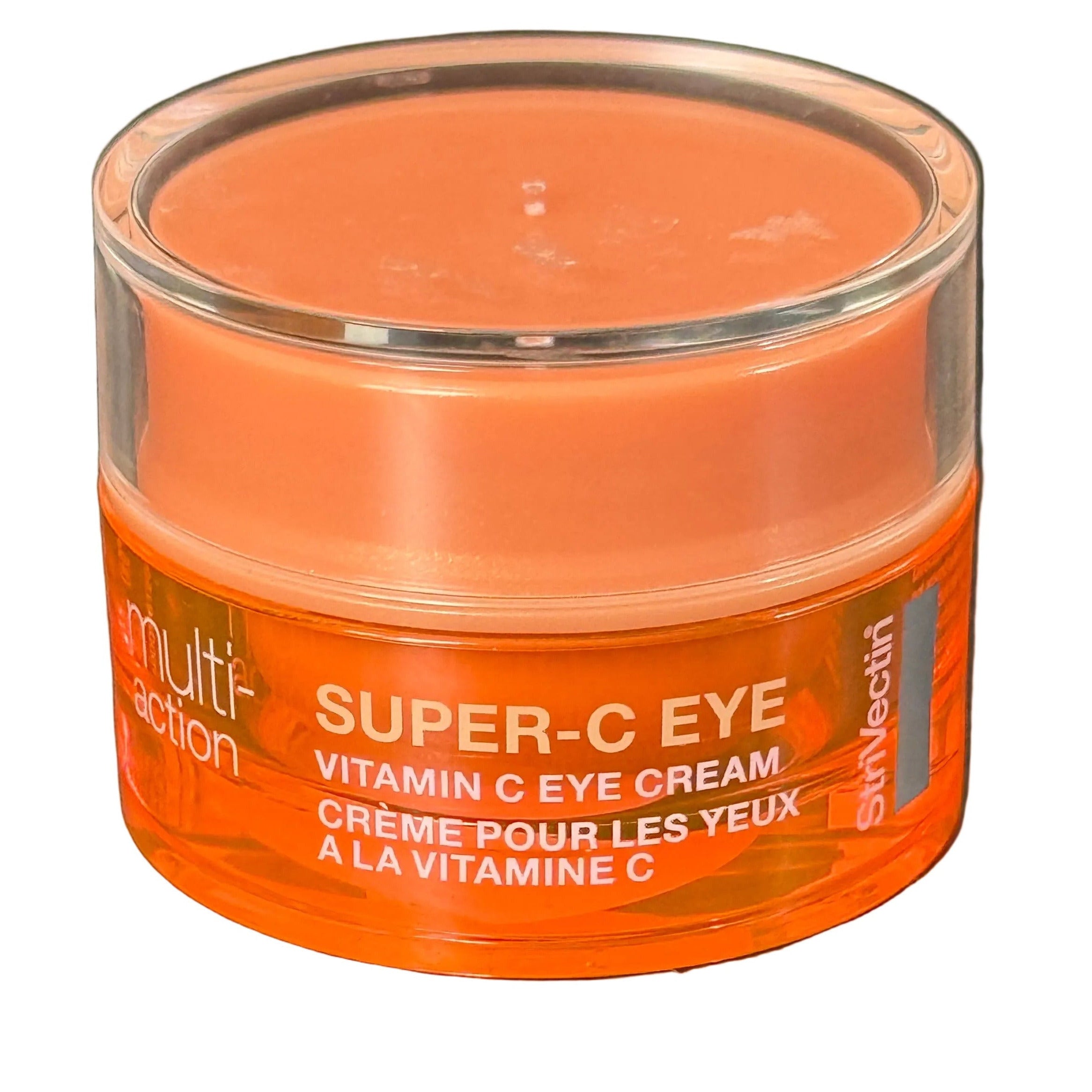 Orange jar of Super-C Eye Cream on a dark surface