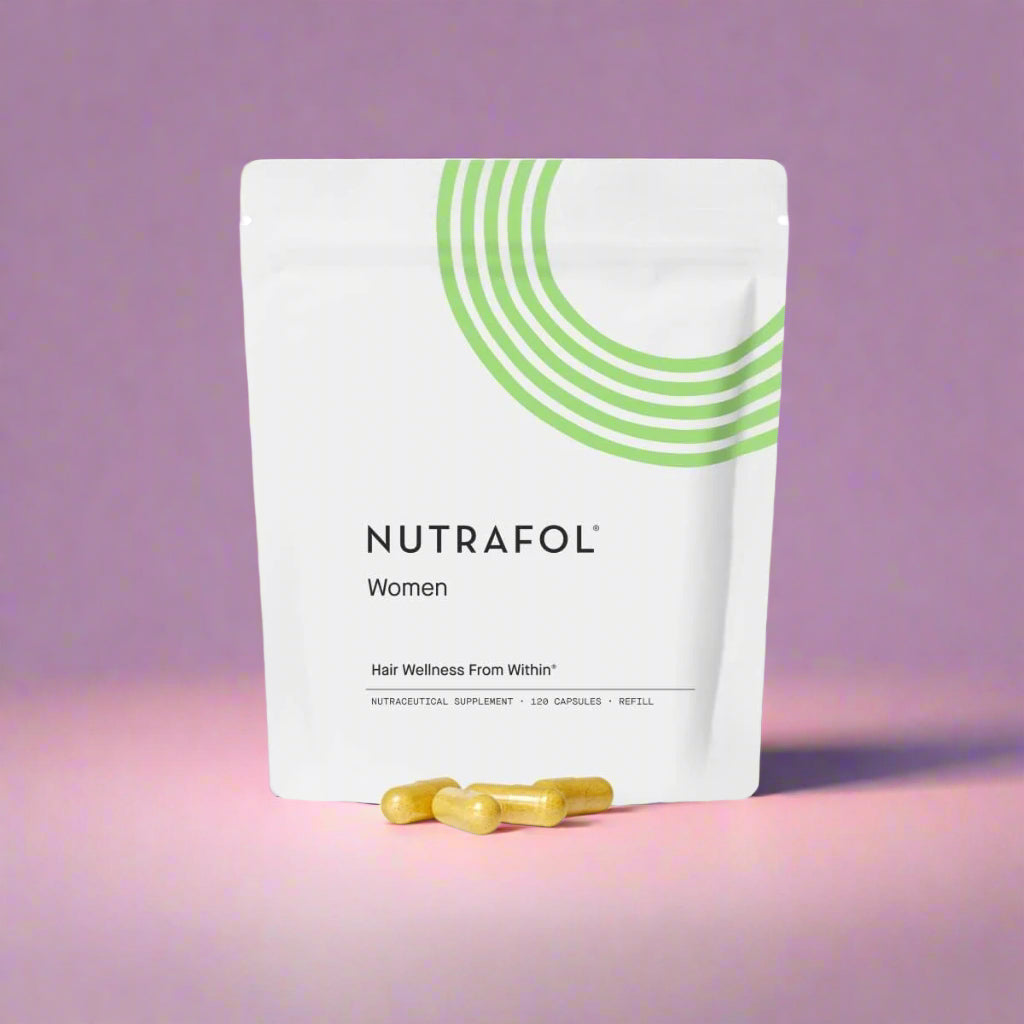 Nutrafol supplement package for women on a pink background