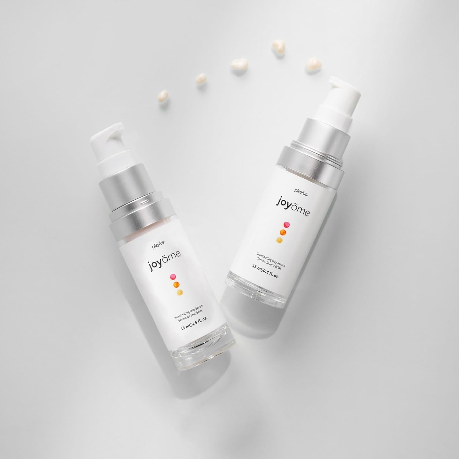 Two 'joyome' skincare bottles on a light gray background