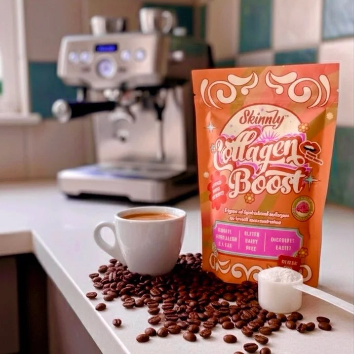 Skinnly Collagen Boost package on a kitchen counter with coffee and beans