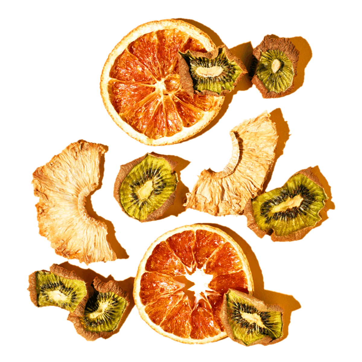 Dried oranges and kiwis arranged in a circular pattern on a white background