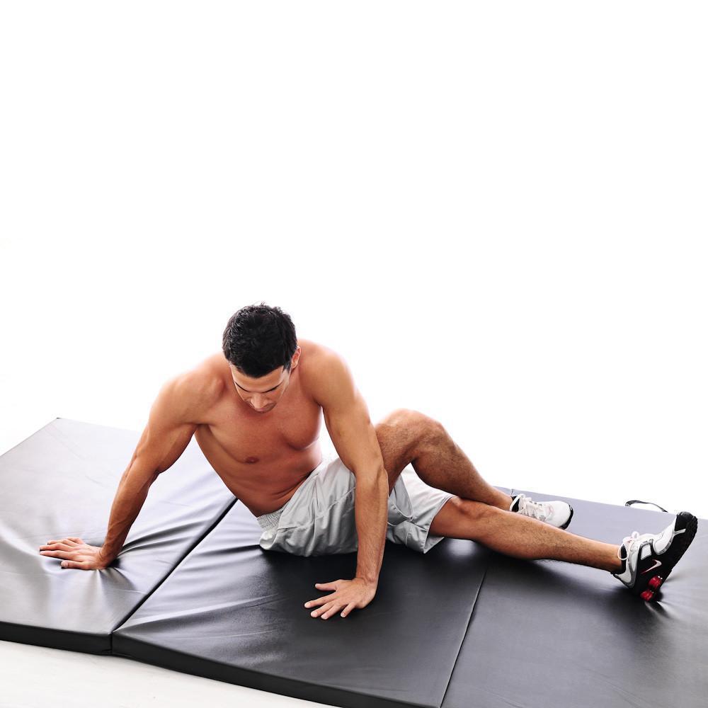 Perform stretches on TKO 3' x 6' Tri-Fold Gym Folding Exercise Mat.
